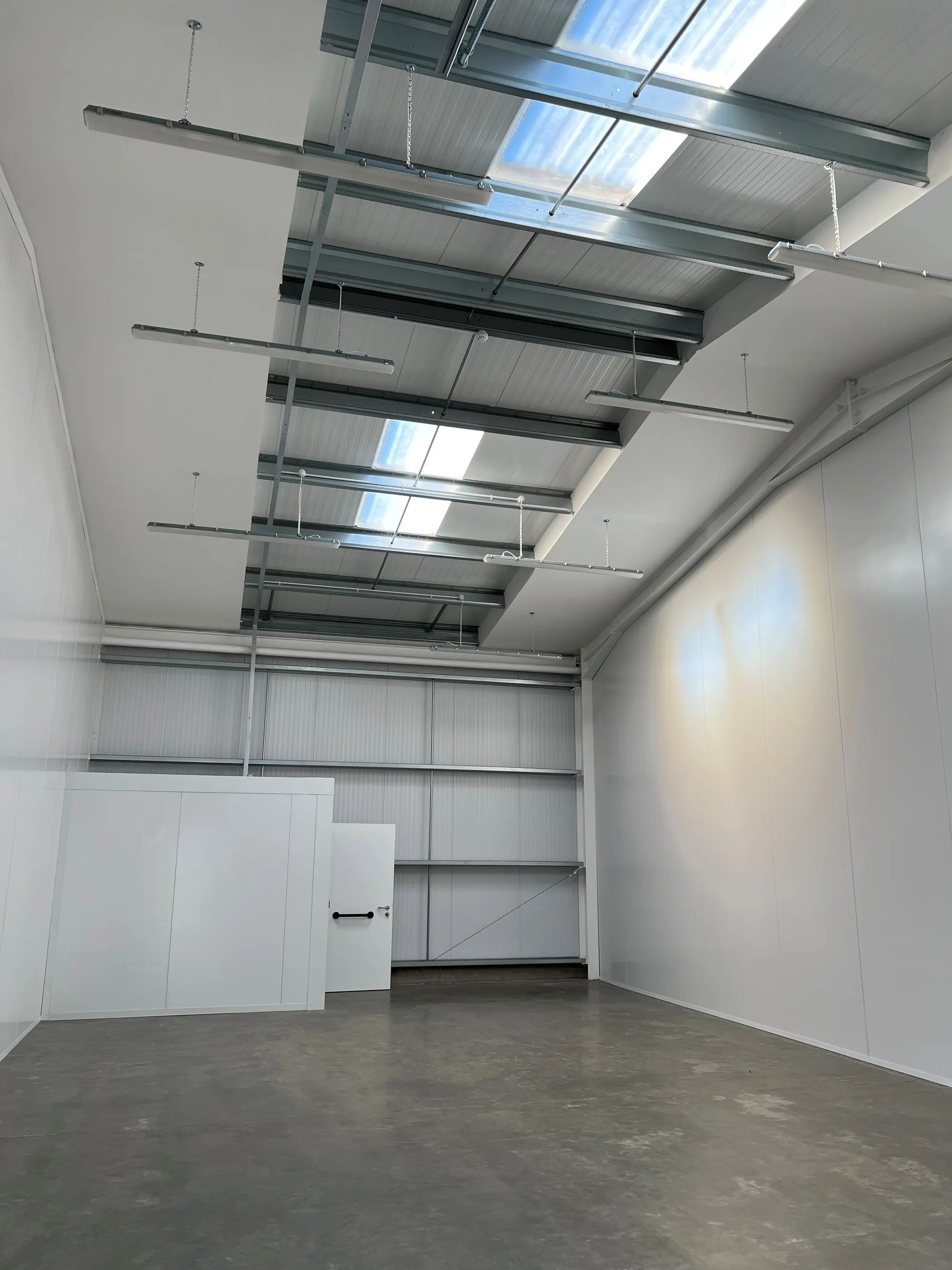 Inside one of the Livingston business units, lit by rooflights